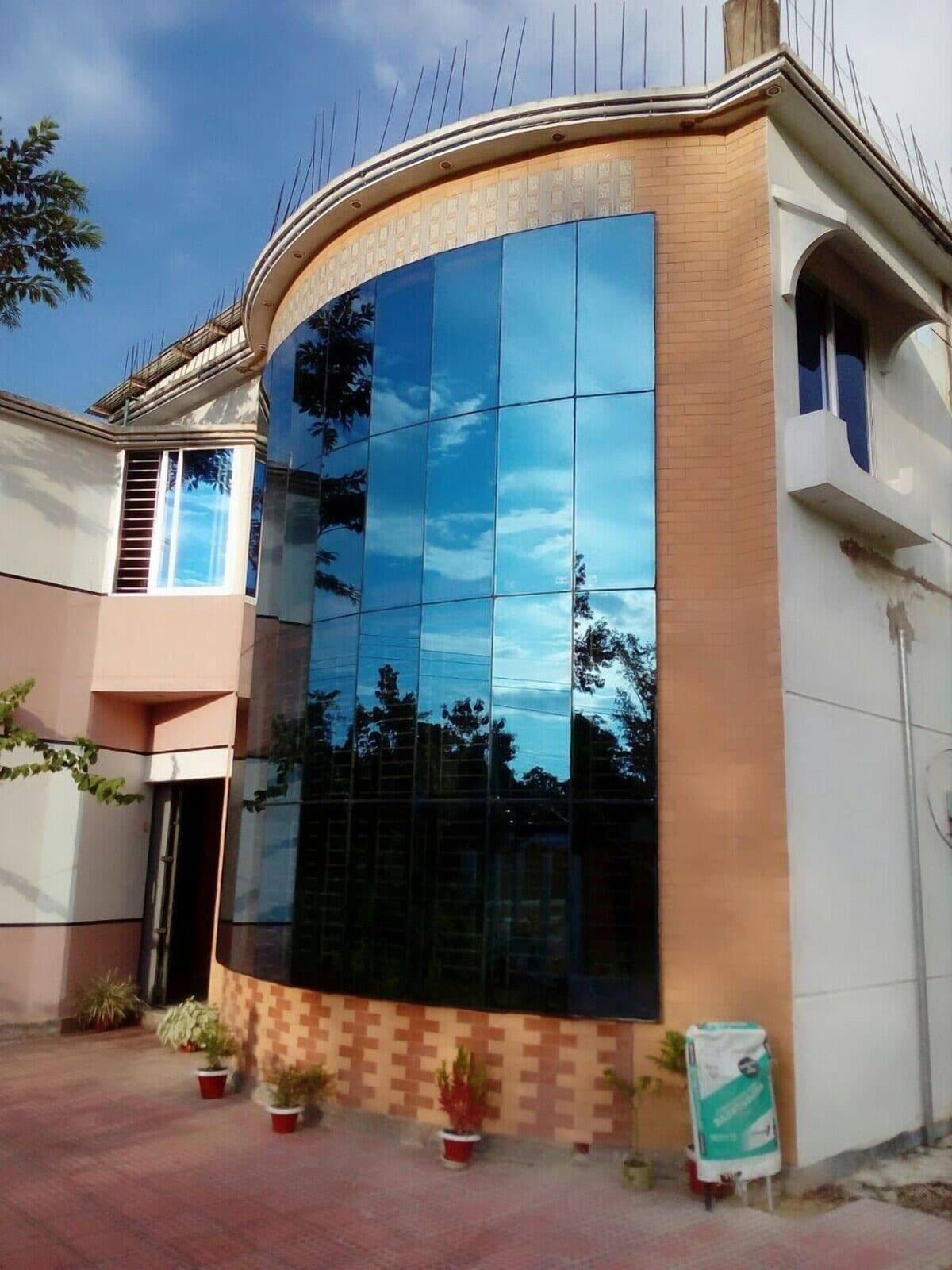 Tony's Place's curved glass-and-brick front facade against a blue sky